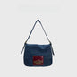Original Denim and Leather Hand Bag with a Glossy Logo Patch Design in Blue Denim with a Glossy Burgundy Leather Patch and Sleek Flap Design - Stylish, Urban for Casual Outings, Shopping, Everyday Use for Women